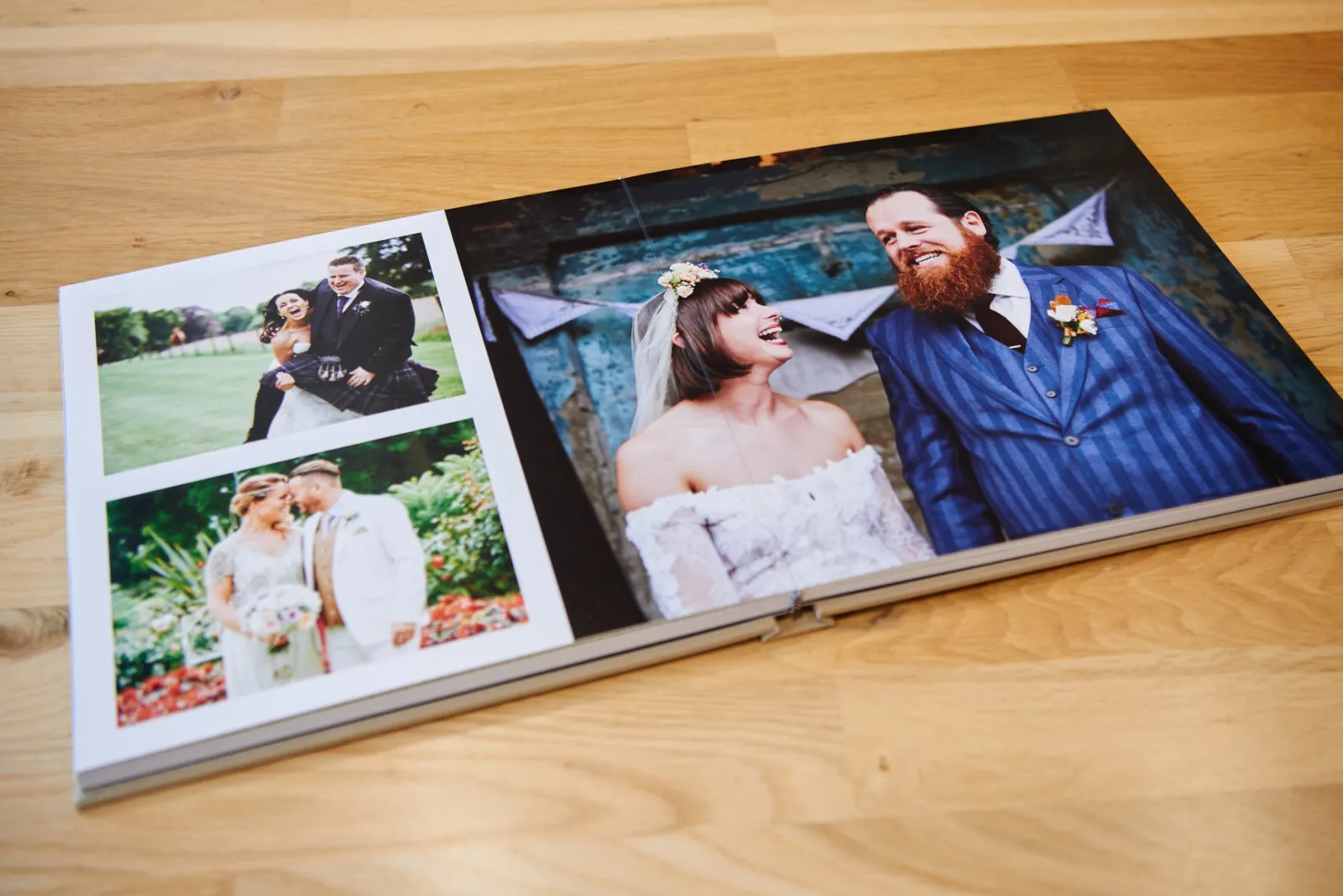Open wedding album on floor showing a photo of alternative bride and groom