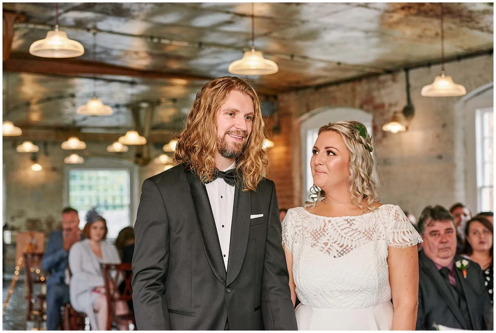 Bride and groom smiling during their industrial wedding ceremony at theWest Mill Venue in Derby