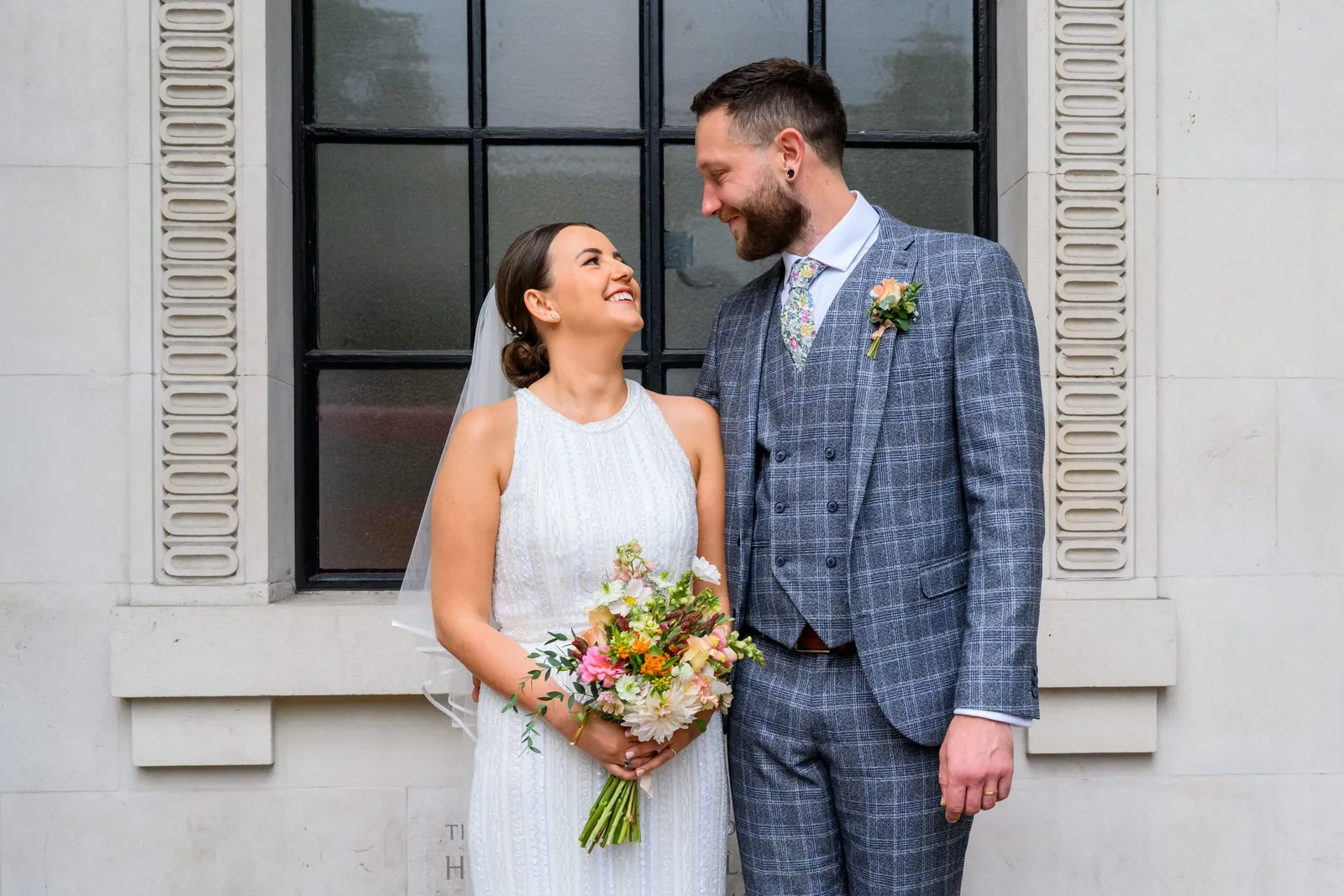 happy and relaxed bride and groom during their town hall photography session