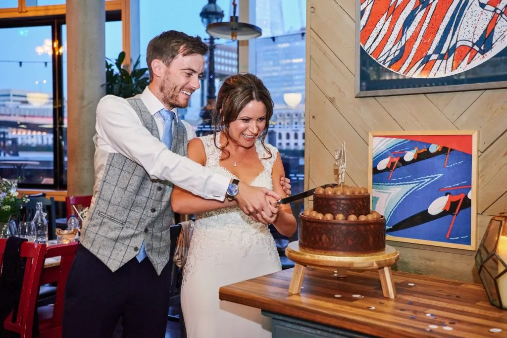 Bride & Groom cutting chocolate wedding cake at The Oyster Shed in London