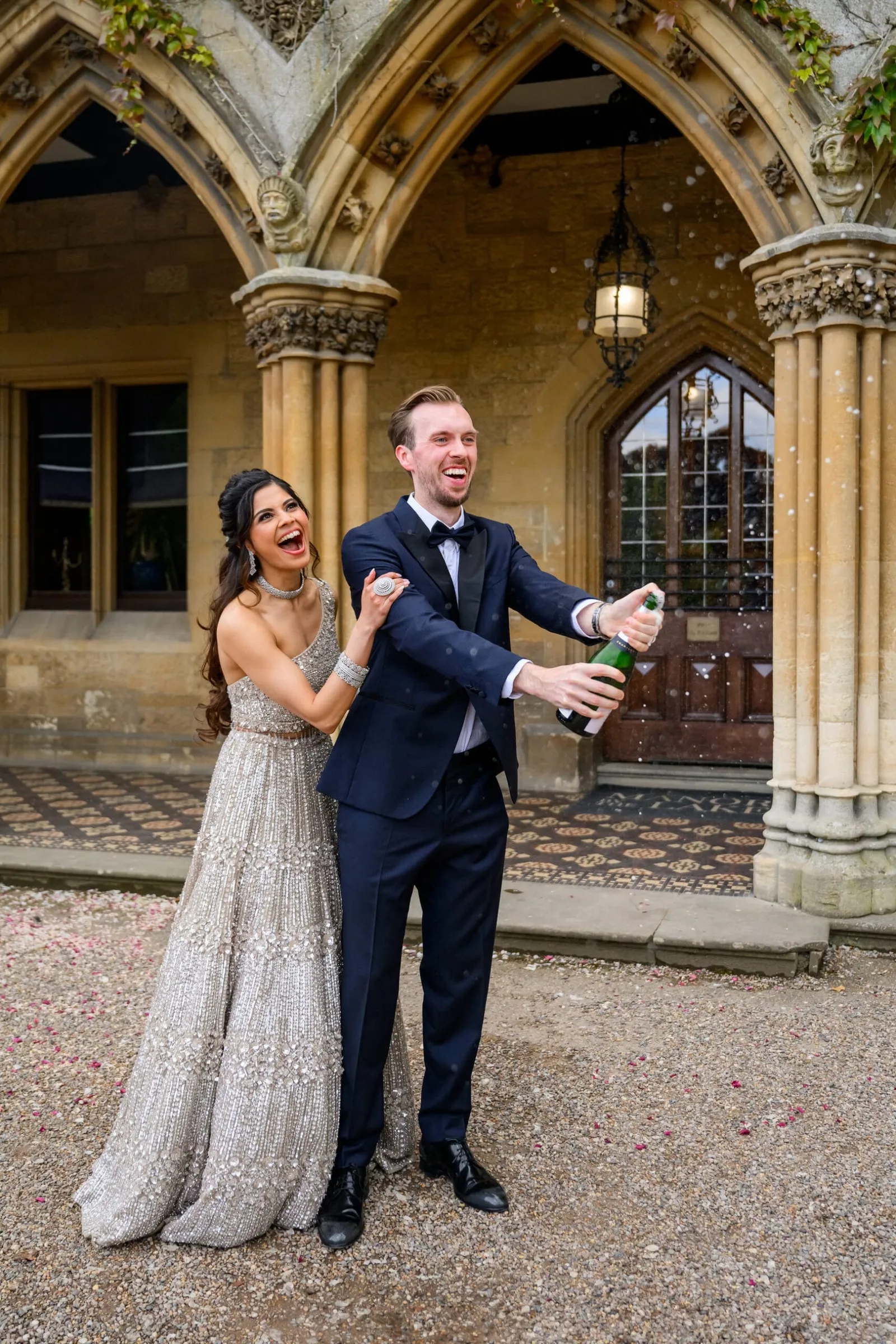 Bride and groom spraying champagne during Nottingham wedding
