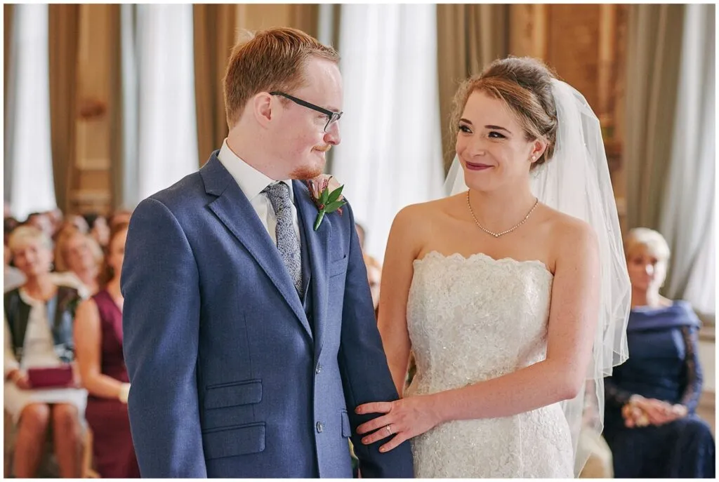 Bride and groom smiling during their wedding ceremony at the Beaumont Estate
