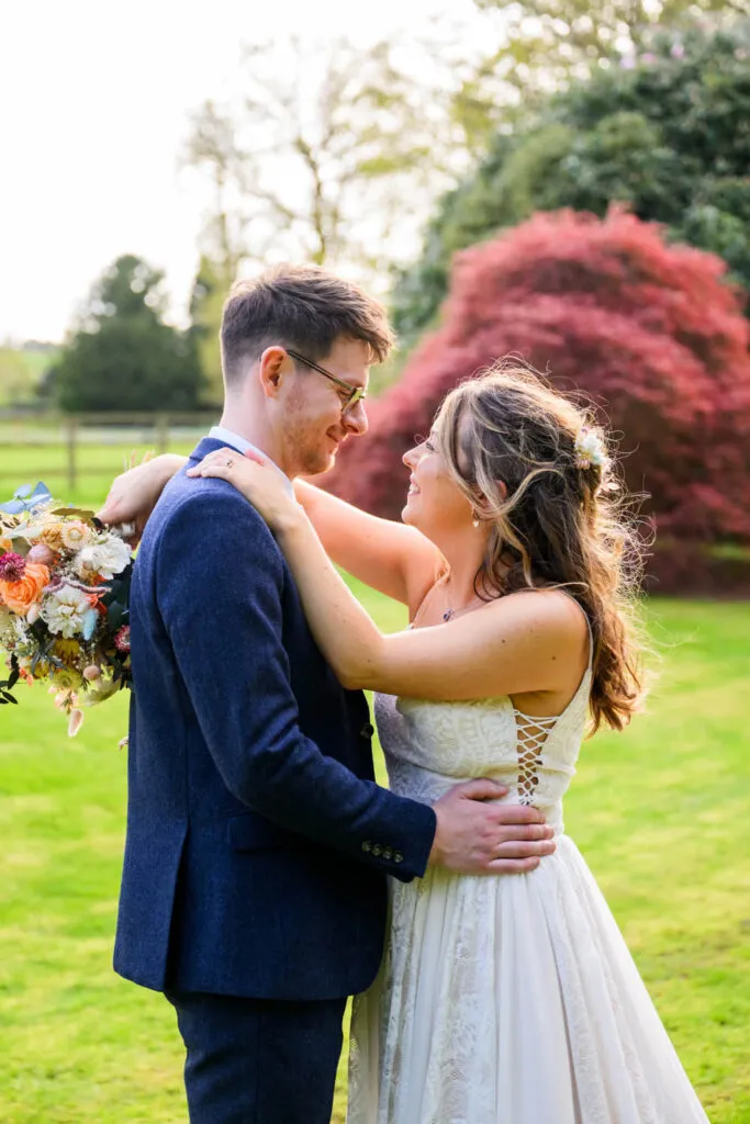 bride and groom embracing during woodborough hall wedding portraits