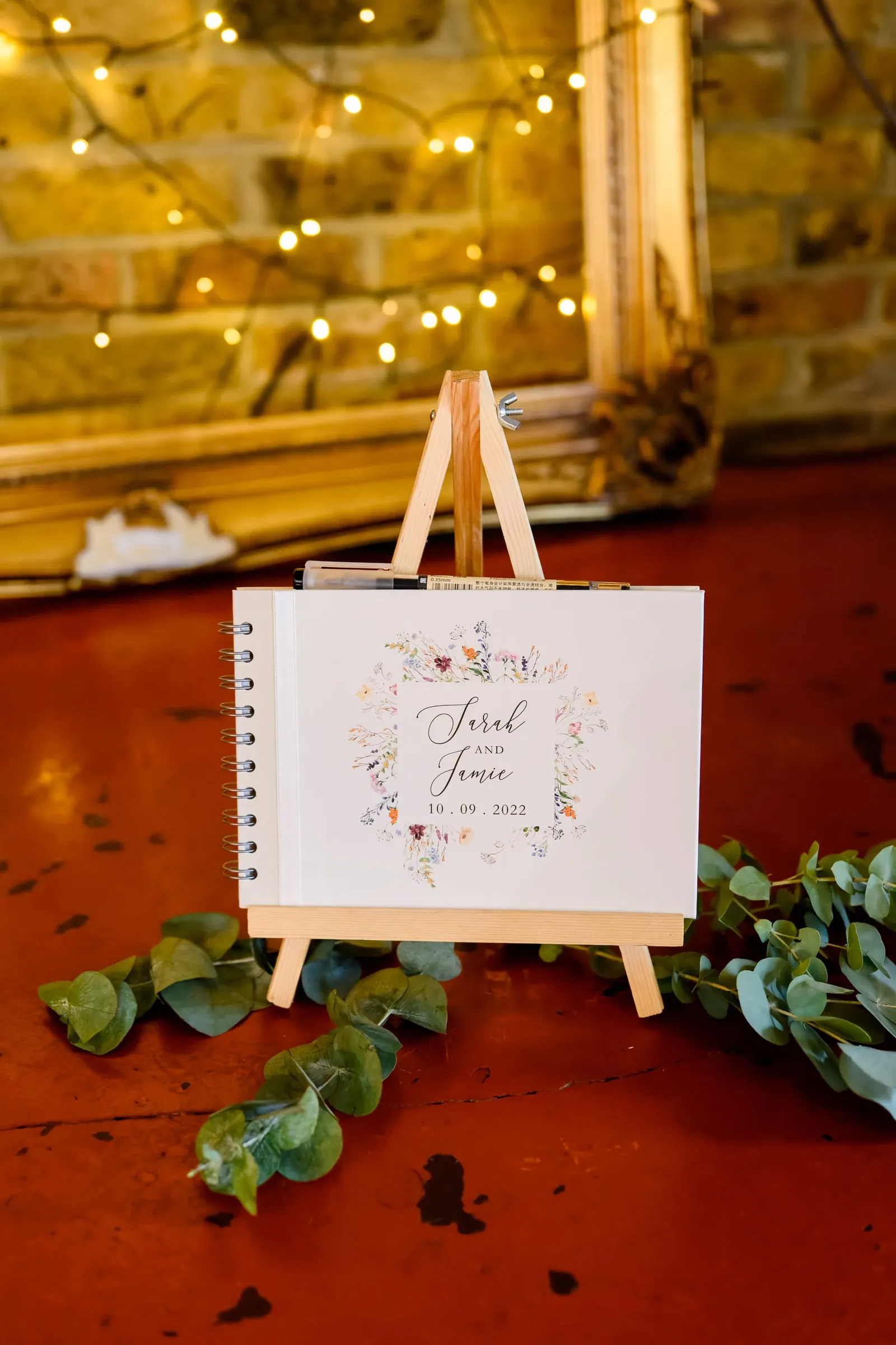 wedding guest book in front of rustic brick wall at The Depot N7 