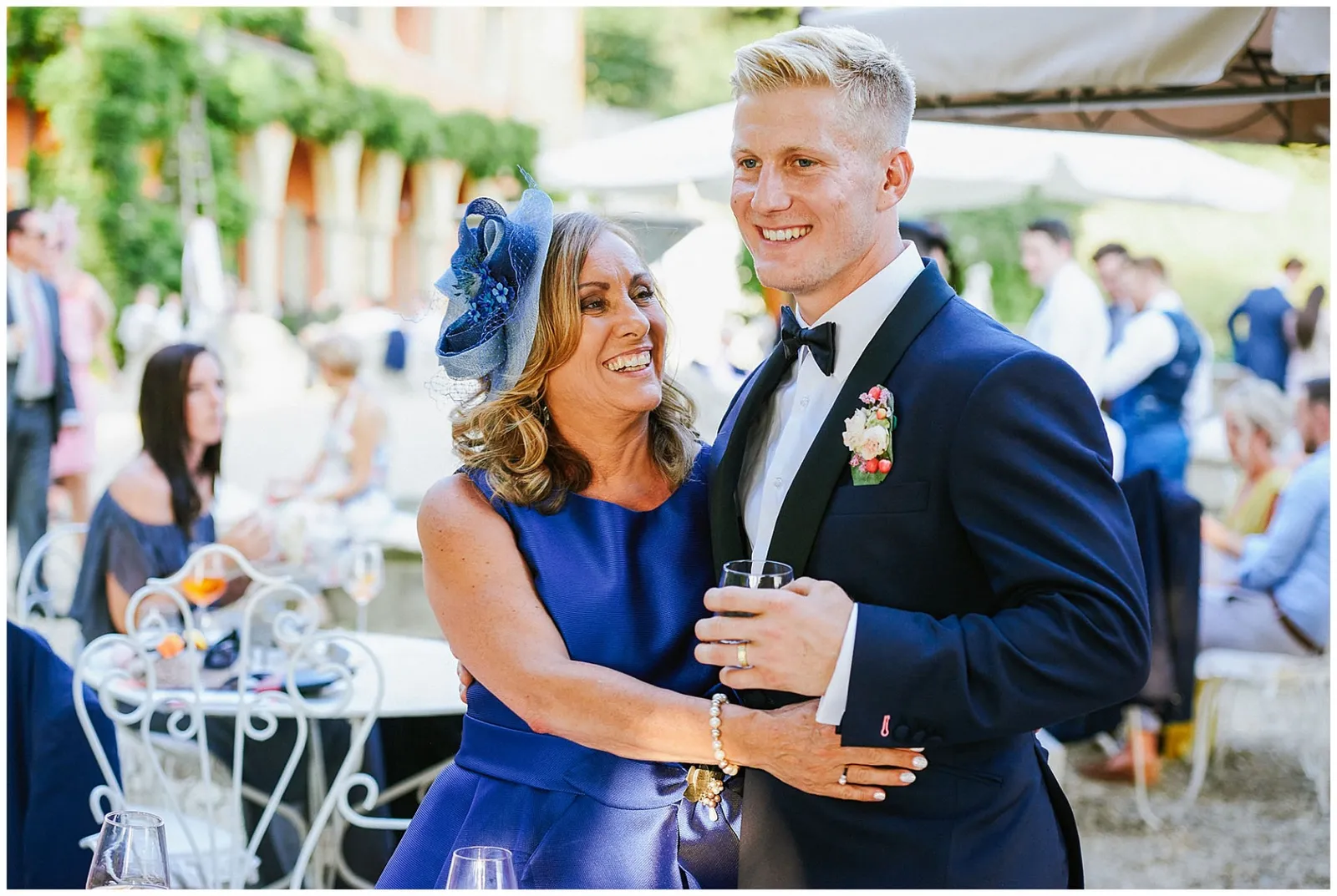 mum smiling with her sun during sunny Italian wedding