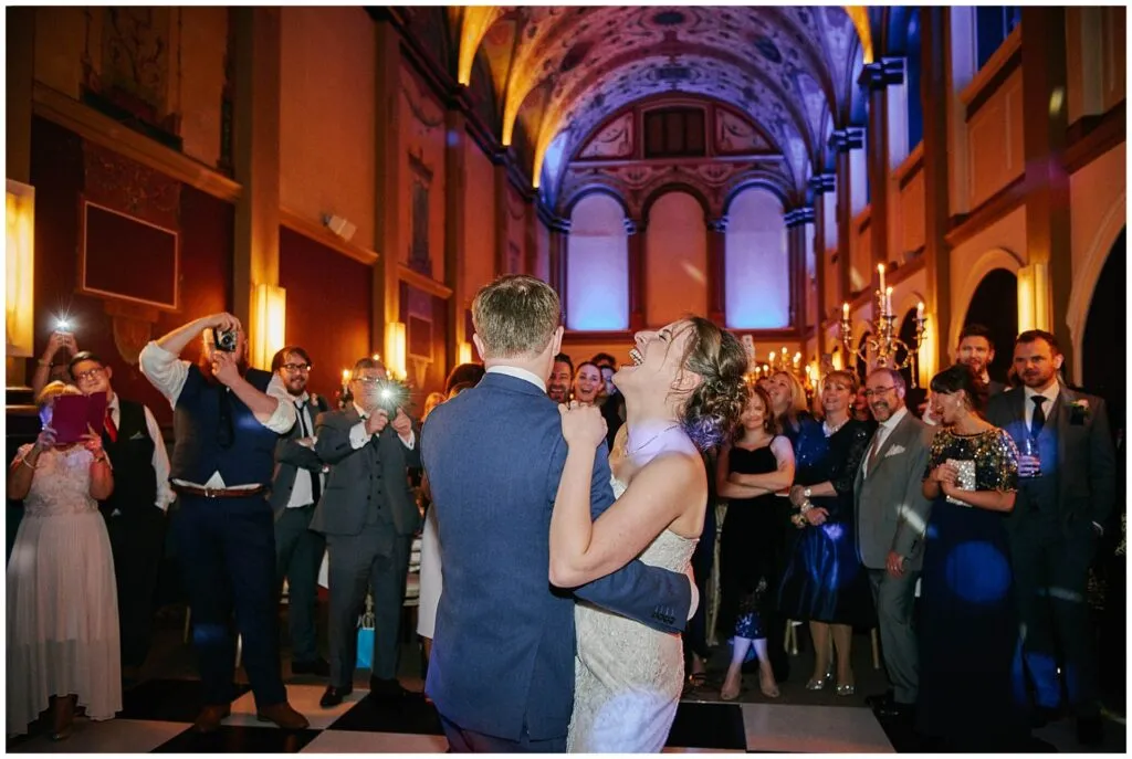 Fun bride and groom laughing during their first dance at De Vere Beaumont Estate