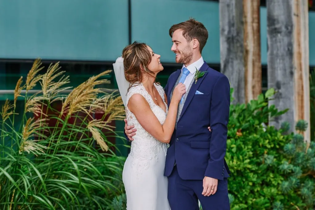 Bride and groom laughing together outside of the Oyster Shed 