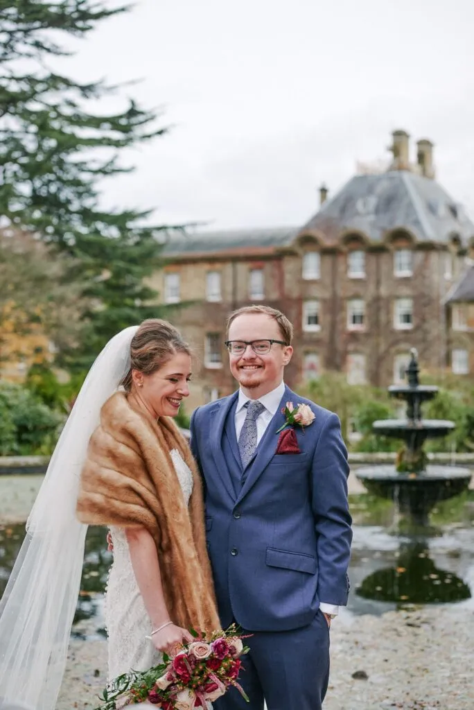 Bride and groom laughing during winter wedding at De Vere Beaumont Estate