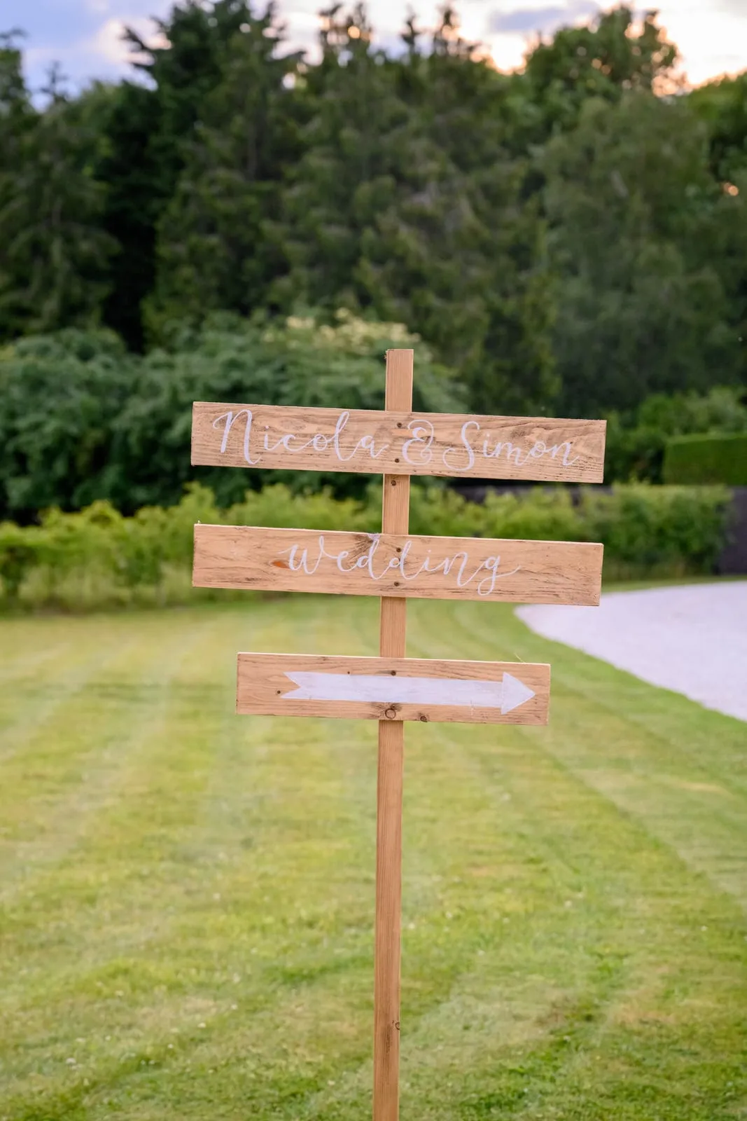 A welcome wedding sign in front of a forest at Hazel Gap Barn