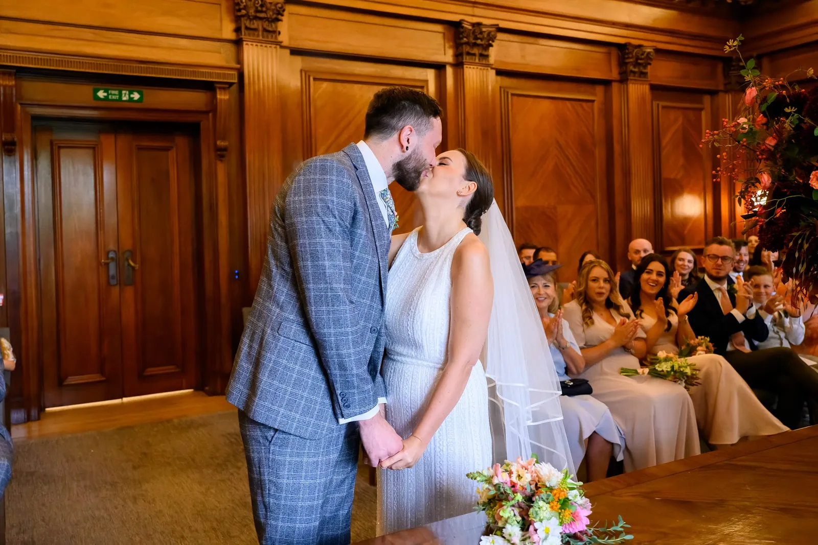 bride and groom kissing during Marylebone wedding ceremony