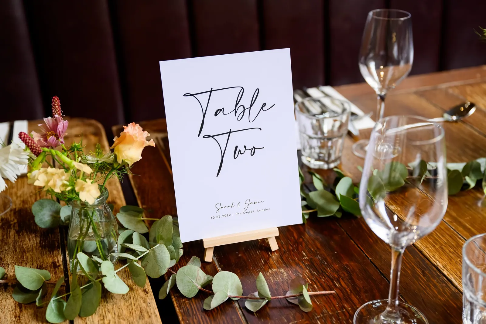table number on wooden table with rustic flowers during the Depot N7 wedding 