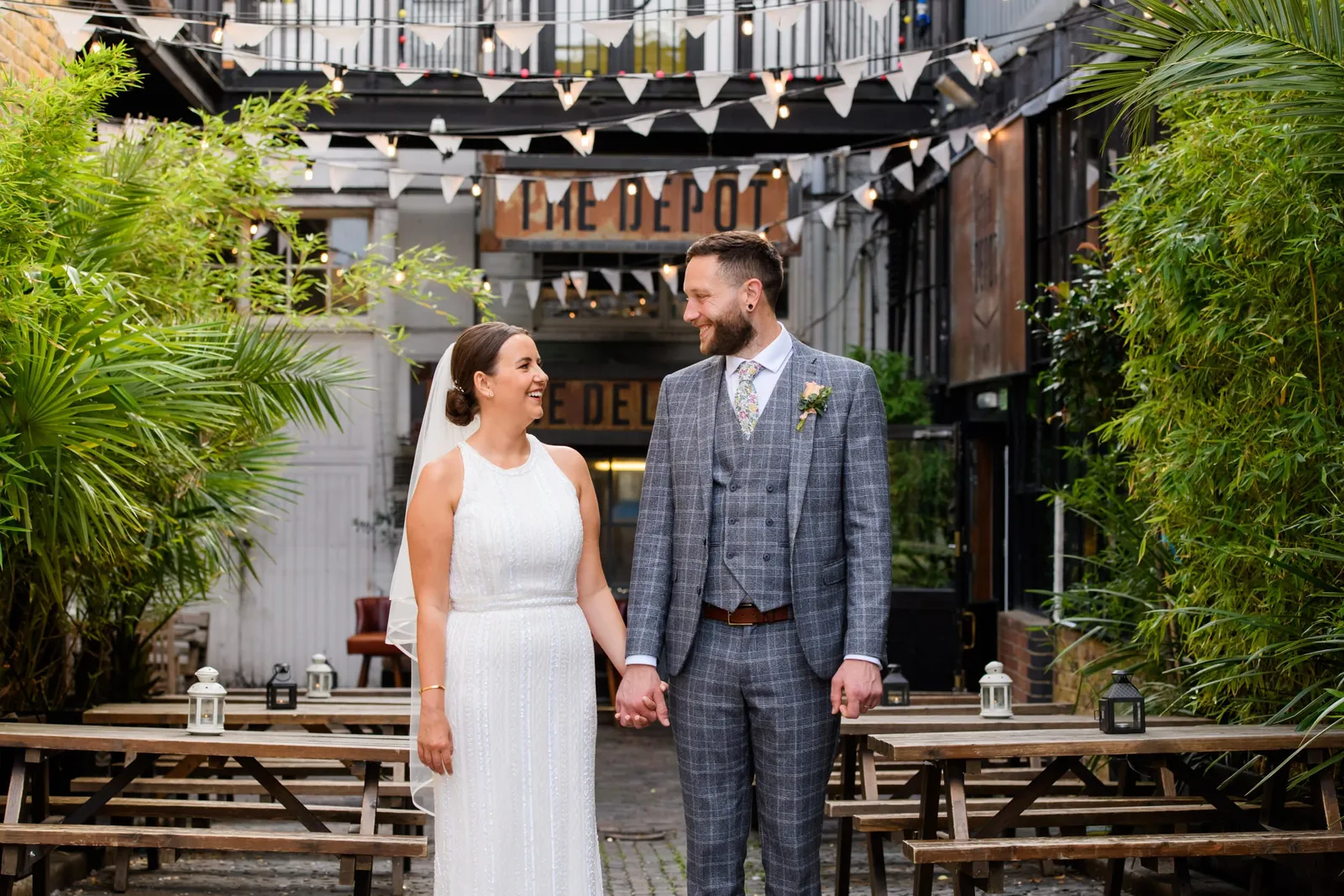 natural photography of Bride and Groom smiling in the courtyard at the Depot N7