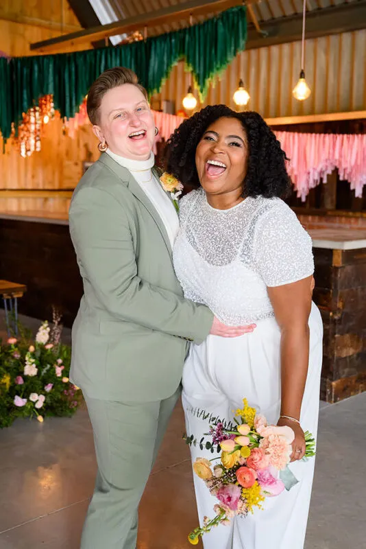 Relaxed couple laughing during wedding portraits in Nottingham