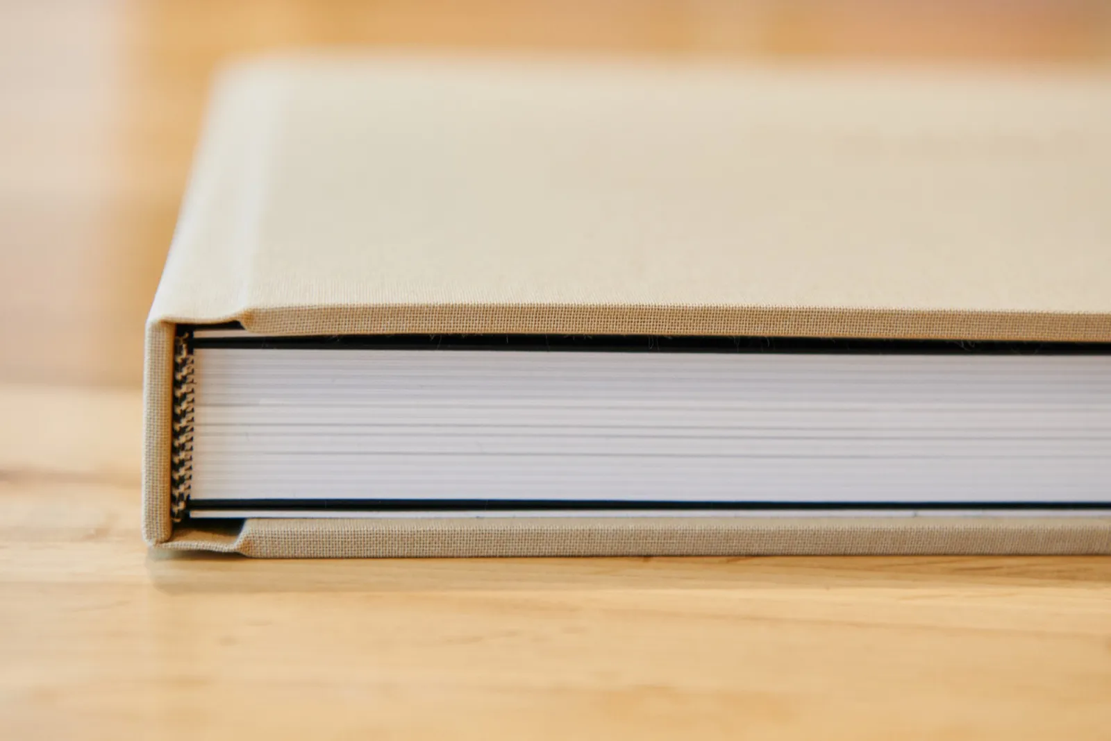 close up of printed wedding album showing thickness of pages