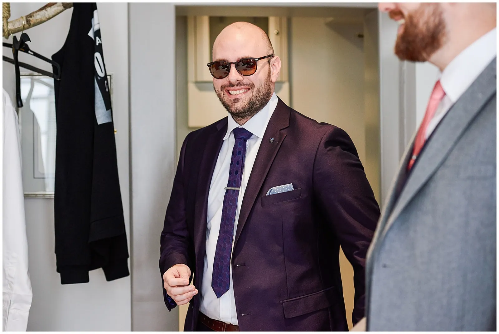 groomsman laughing in hotel room