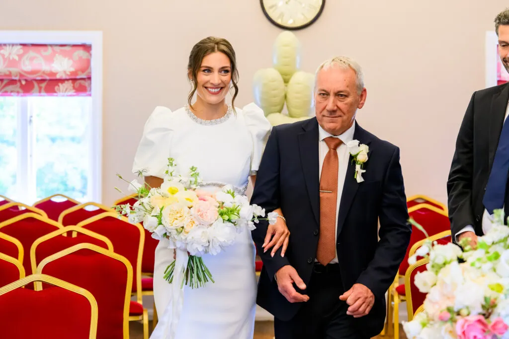 Bride walking into the ceremony at West Bridgford Registry Office with her father