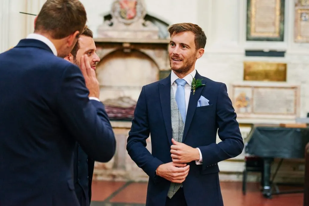 Groom and ushers stood inside St Margaret's Church in central London