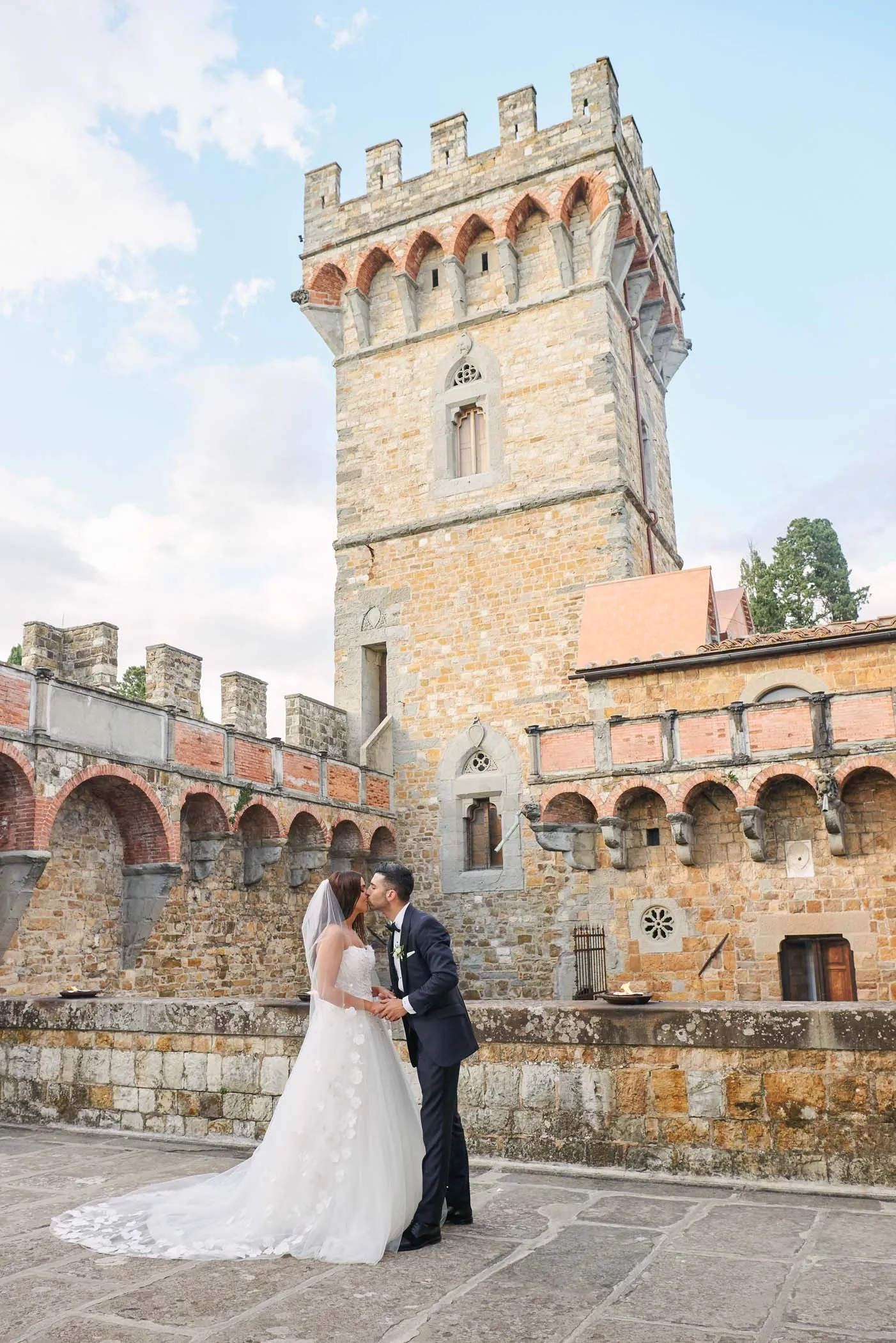 bride and groom kissing during destination wedding at Castello Di Vincigliata