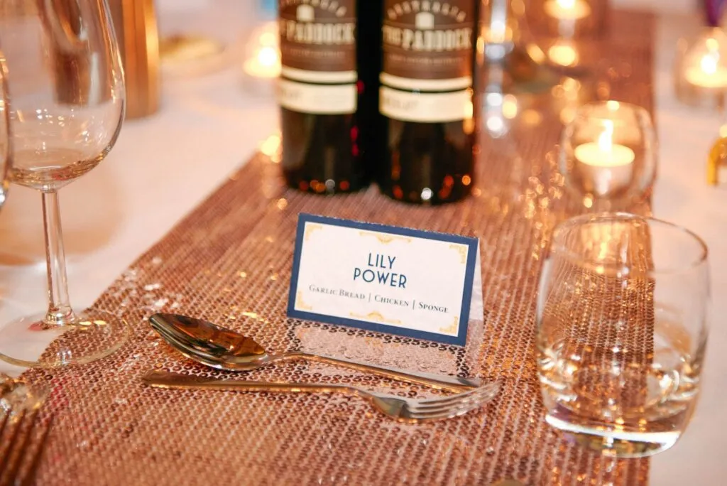 wedding table name card on gold sequinned table runner