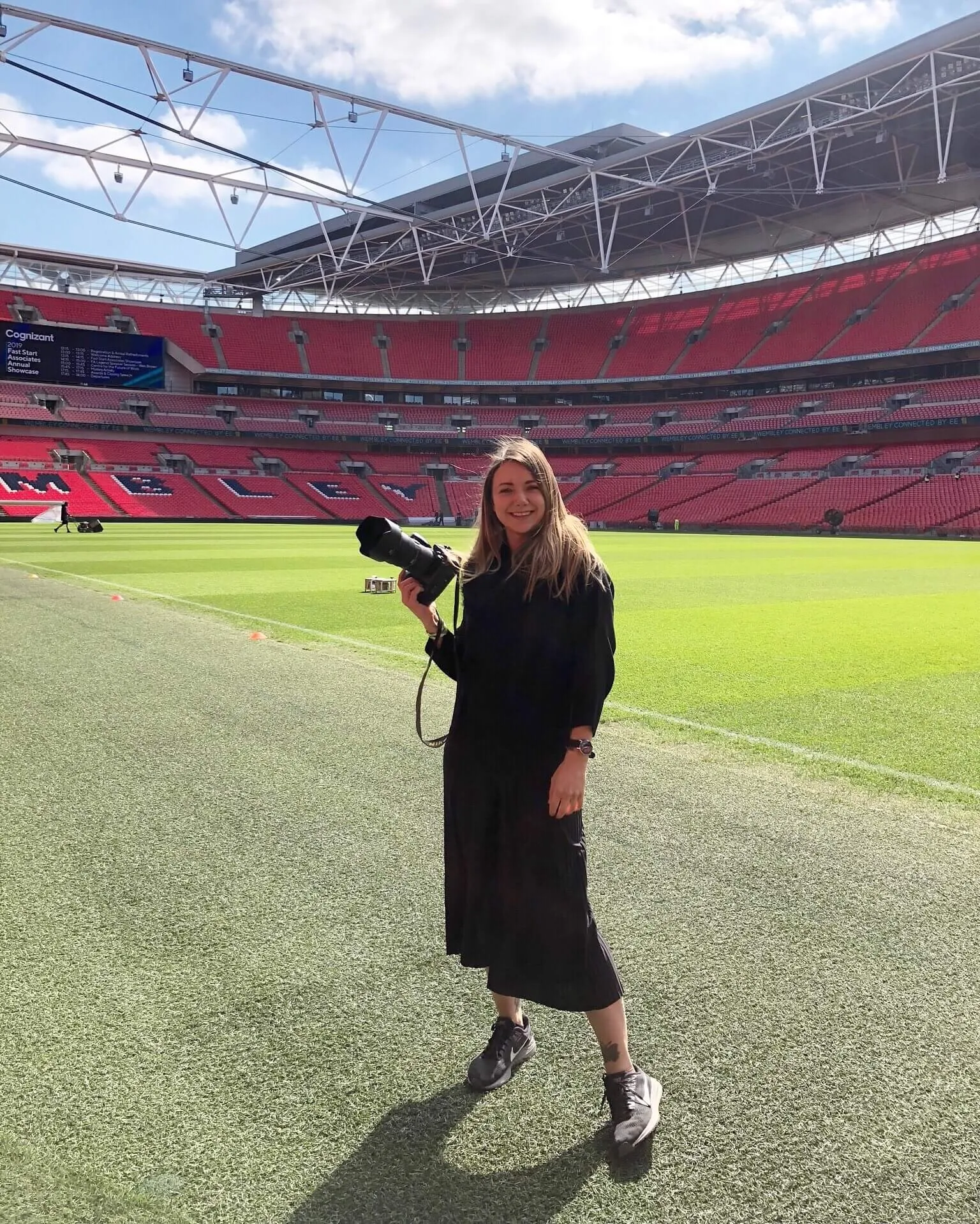 Portrait of wedding photographer Sally Rose stood inside Wembley stadium