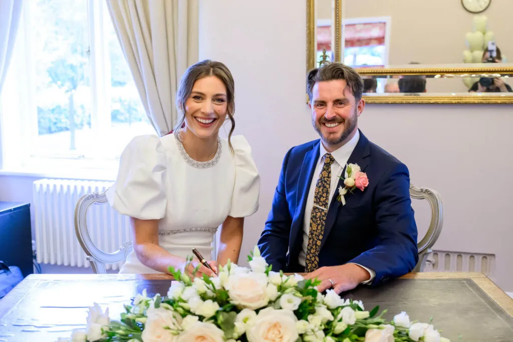 Bride and groom signing the register after their ceremony at West Bridgford Registry Office