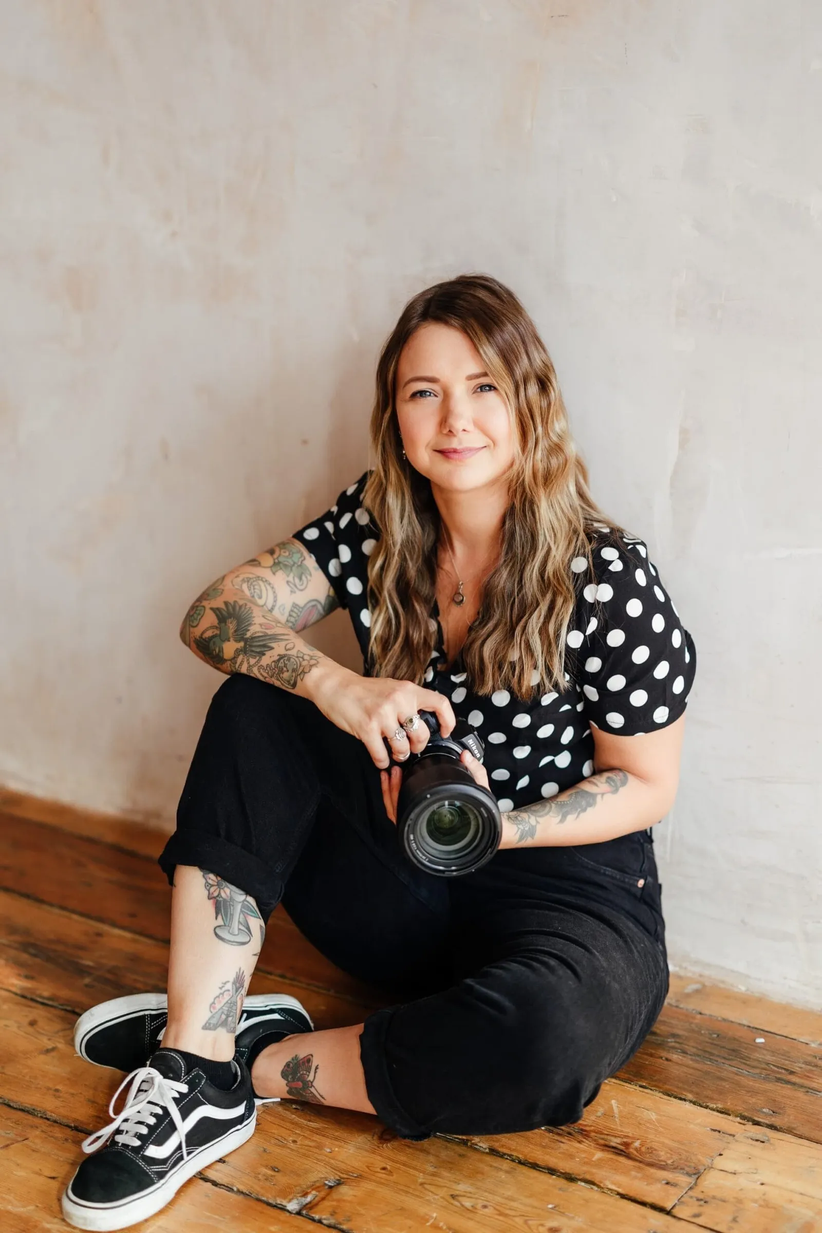 Portrait of Sally Rose nottingham wedding photographer holding a camera
