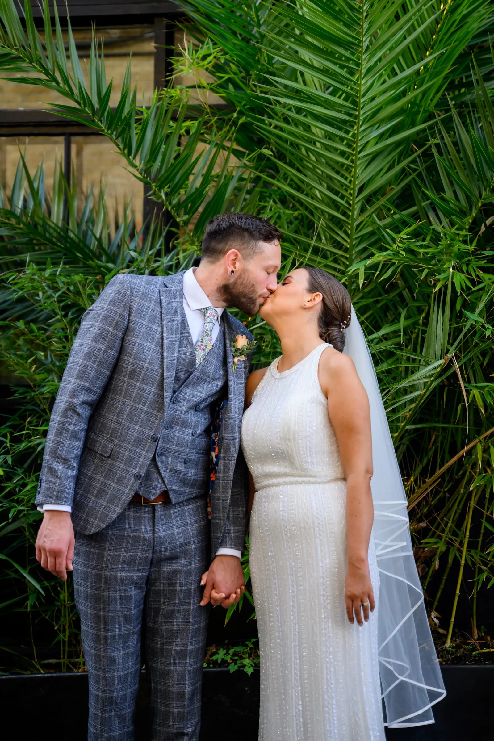 Relaxed photography of Bride and Groom kissing in the courtyard at the Depot N7
