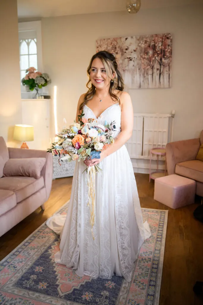 bride holding bouquet during morning preparations woodborough hall wedding photography