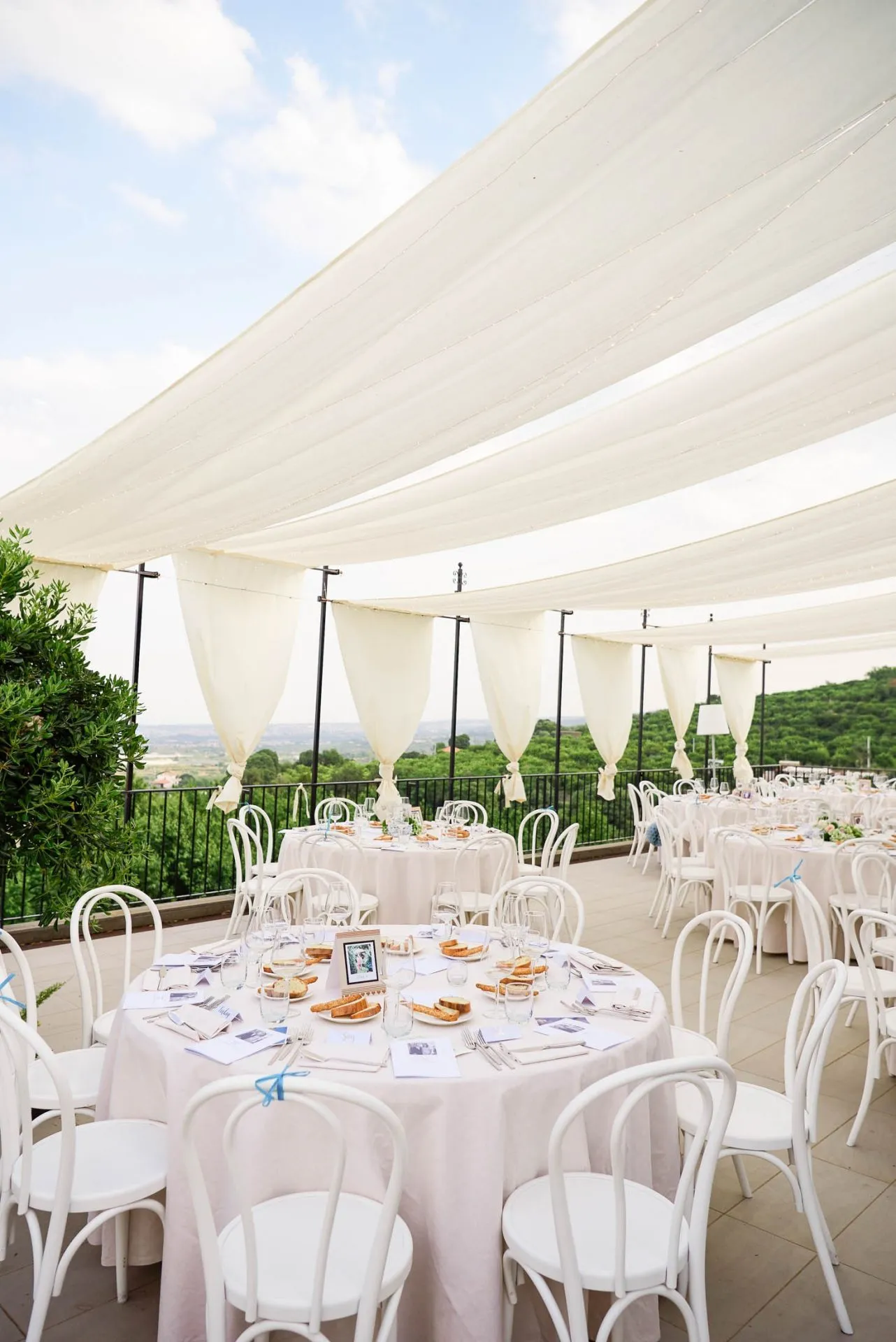 beautiful scenic view of Taormina with empty round table set up at the Talé Hotel in Sicily