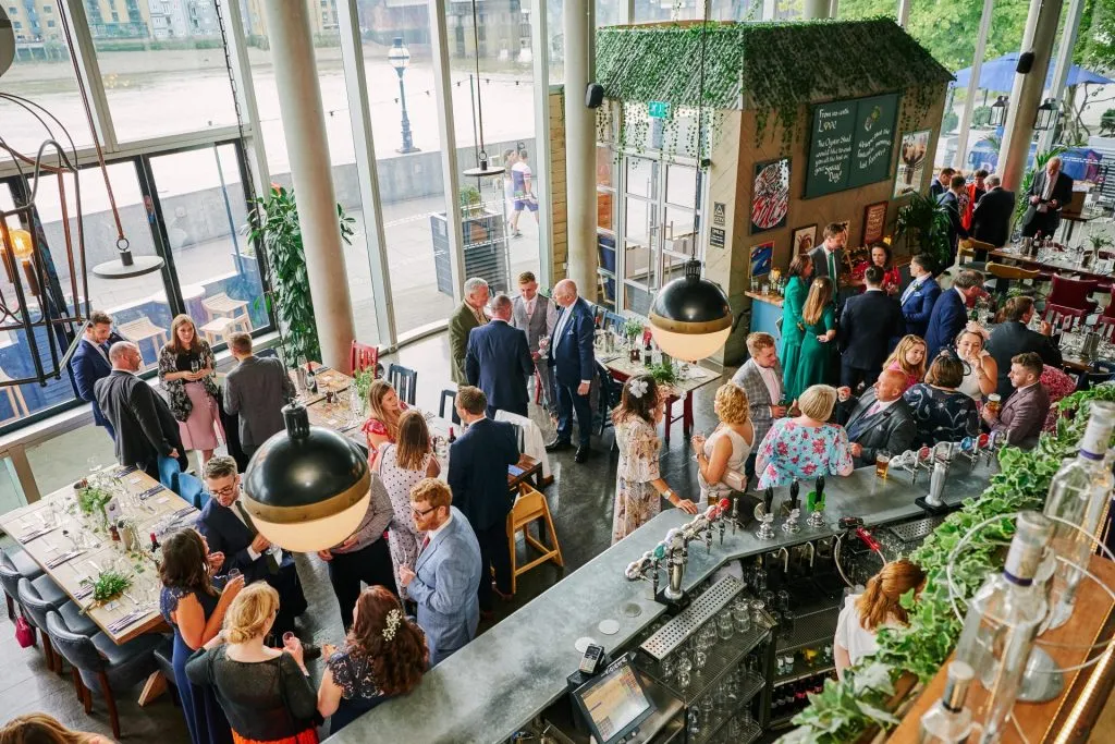 Wedding guests socialising at the The Oyster Shed in London City 
