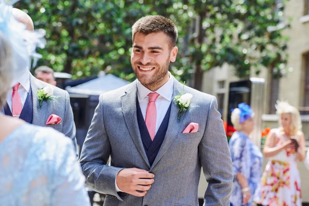 best man smiling during summer courtyard wedding at Devonshire Terrace