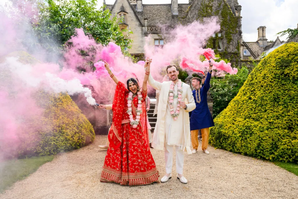 fun bride & groom with with colourful smoke bombs at Hazel Gap Barn