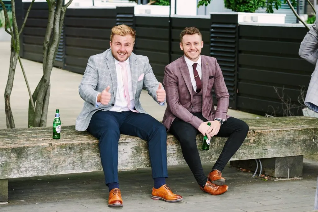 Wedding guests sat drinking beer outside of The Oyster Shed in London 
