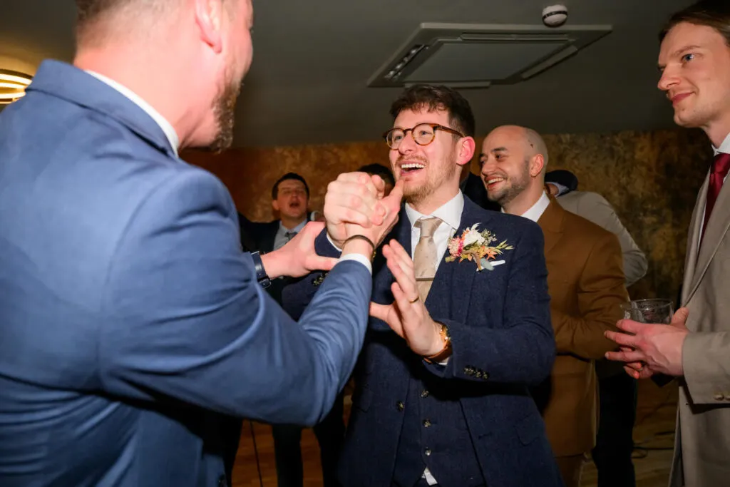 groom dancing and luaghing during woodborough hall wedding reception