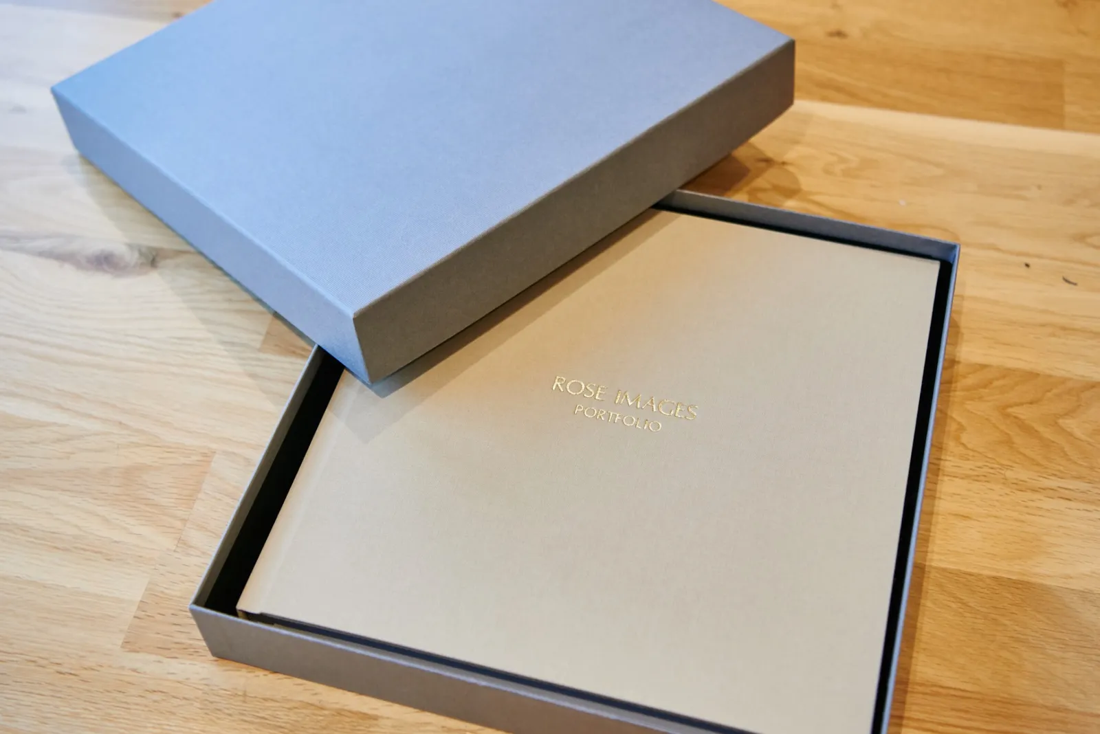 Photography wedding album in grey box on wooden floor