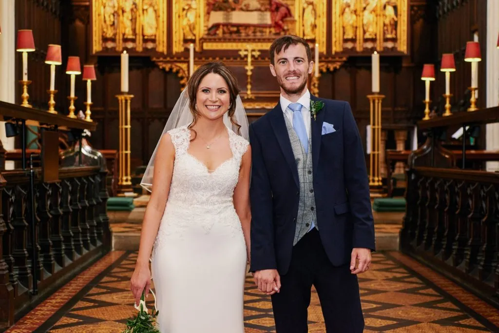 Bride and groom smiling together after getting married in St Margret's Church in London 