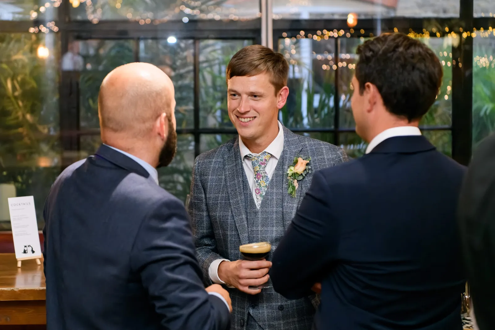 Candid photography of wedding guest drinking craft beer at The Depot N7 