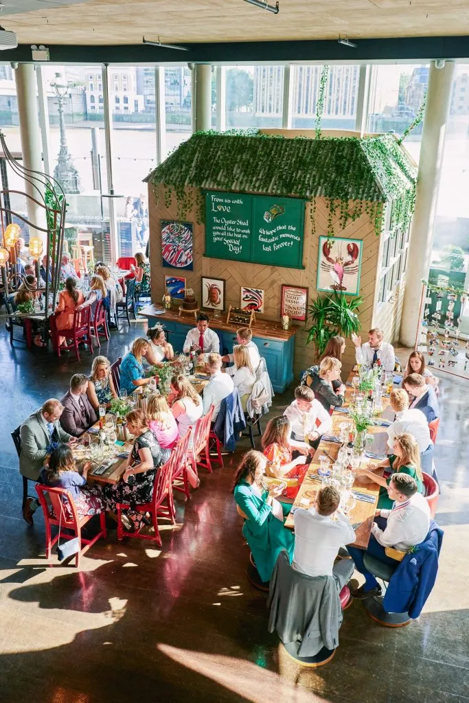 Wedding guests sat down for dinner at The Oyster Shed riverside venue 