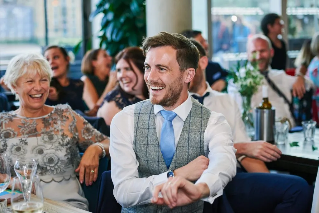 groom laughing during wedding reception at The Oyster Shed