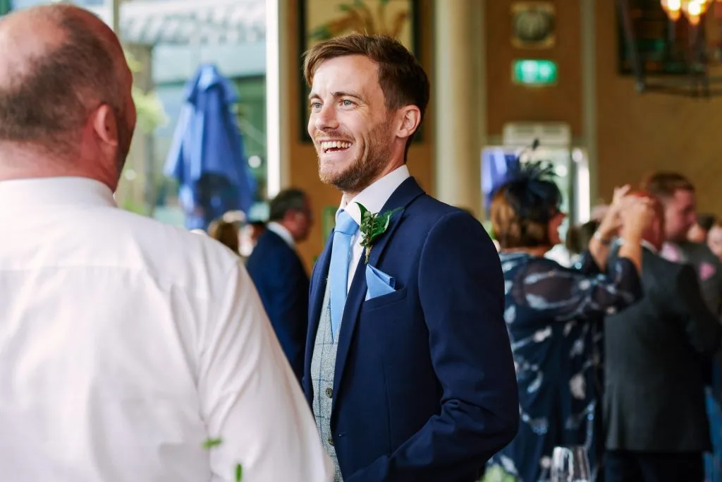 Groom laughing on his wedding day at The Oyster Shed 
