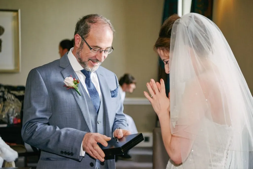 father of the bride giving his daughter a gift during london wedding