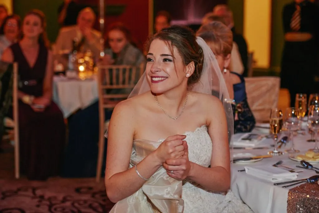 Bride laughing during speeches at fun winter wedding