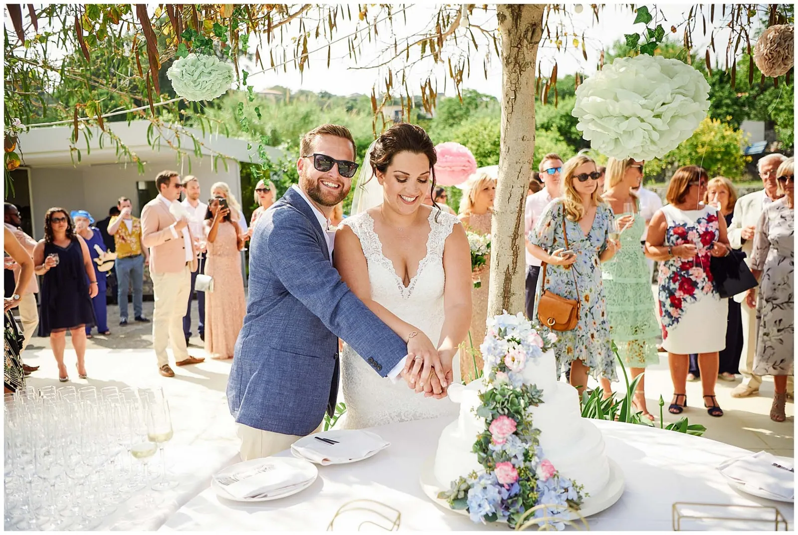 Bride and groom cutting their wedding cake outside during Italian Destination Wedding in Sicily