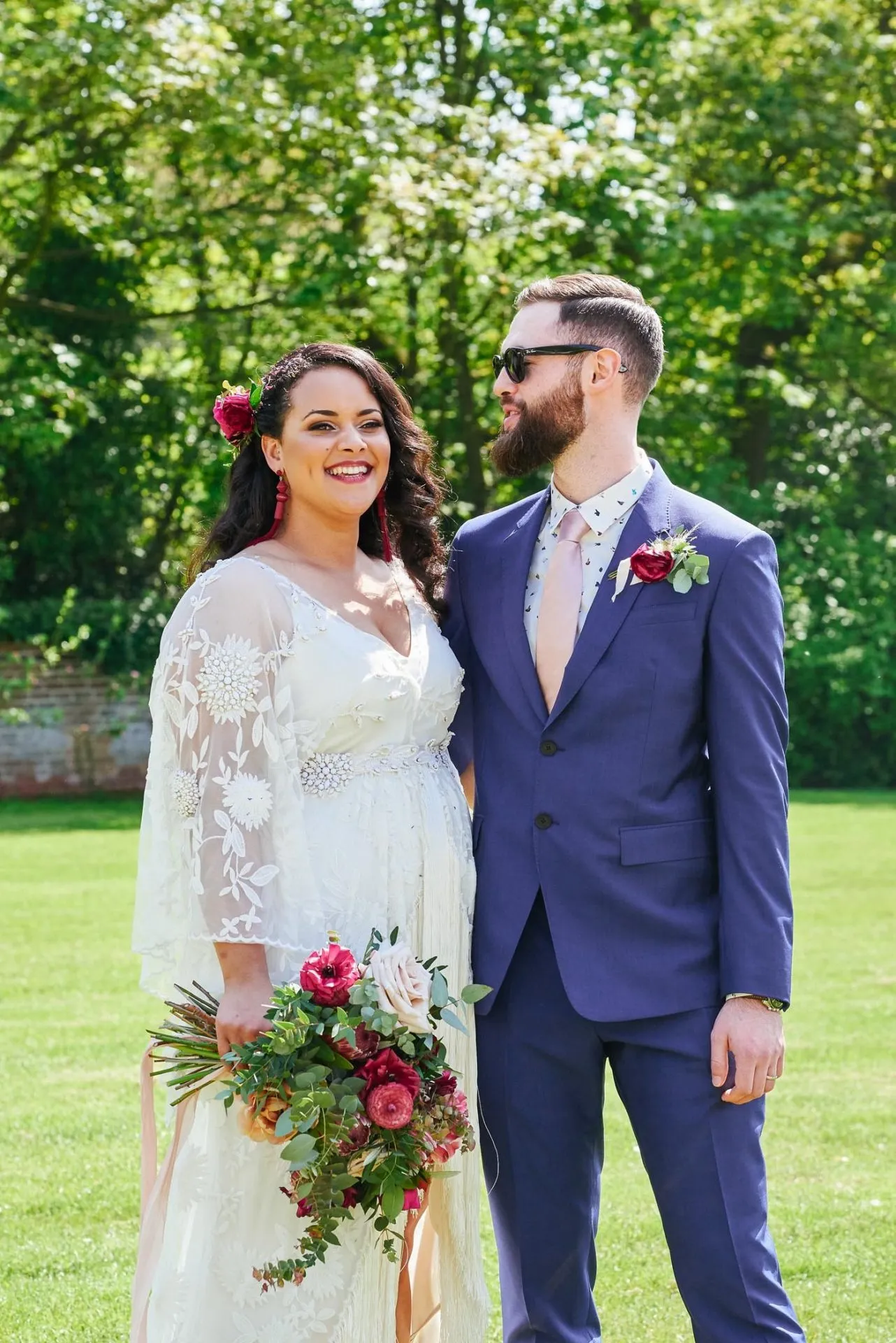Happy bride and groom outside at the walled garden