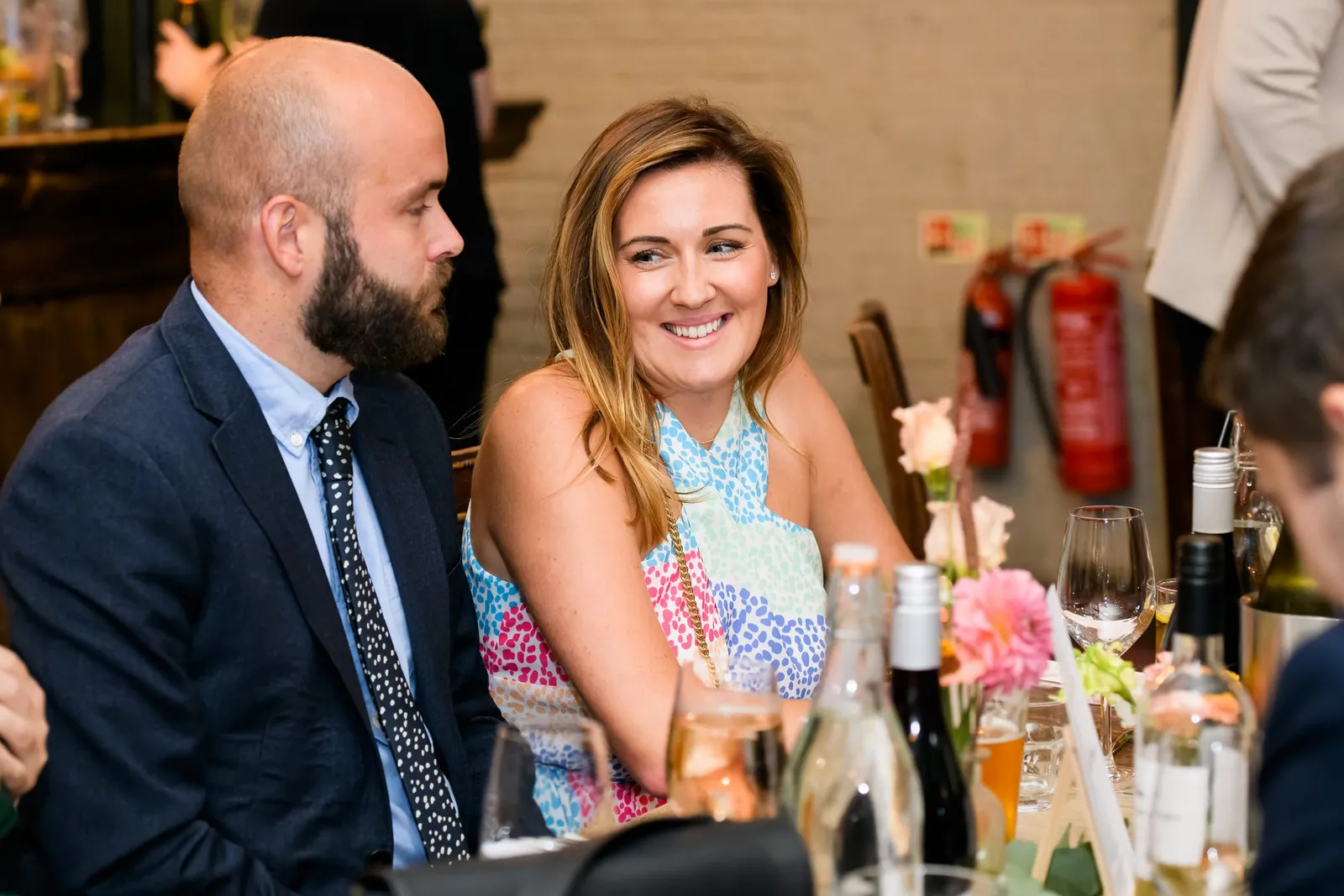 female guests laughing during wedding speeches at The Depot N7