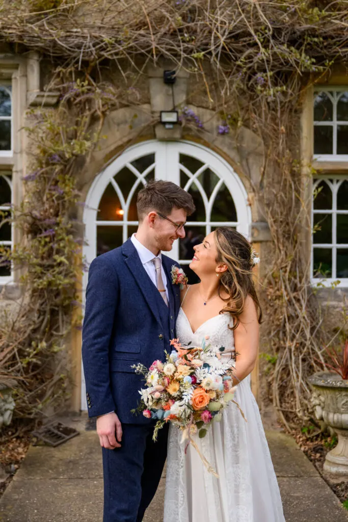 bride and groom portrait outside woodborough hall during wedding portraits