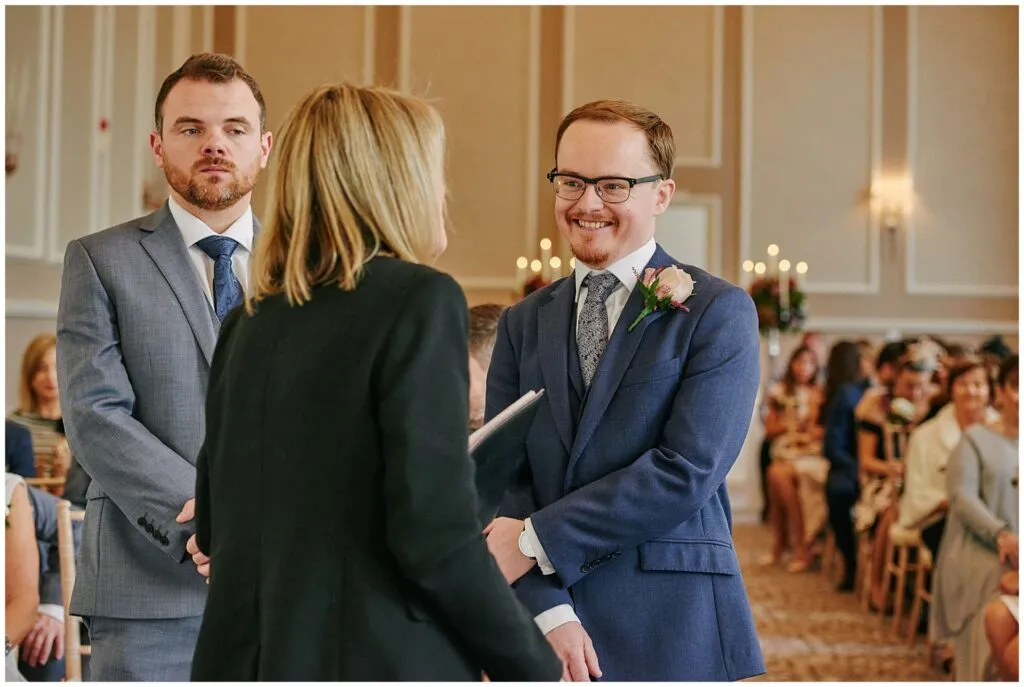 groom smiling during winter wedding ceremony at Beaumont Estate in London
