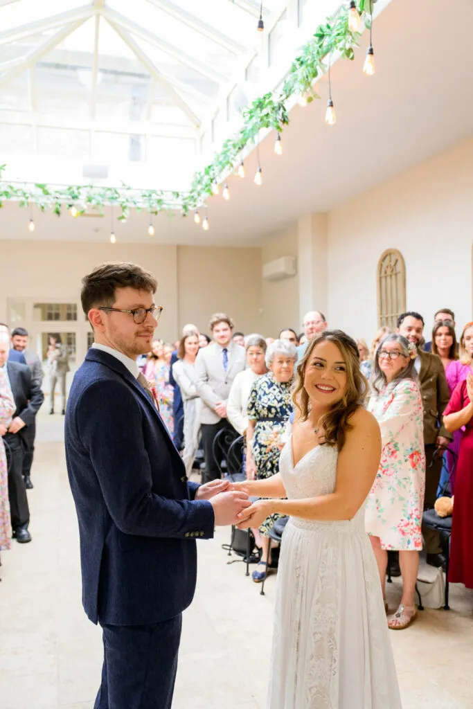 bride and groom standing together during orangery ceremony at woodborough hall wedding