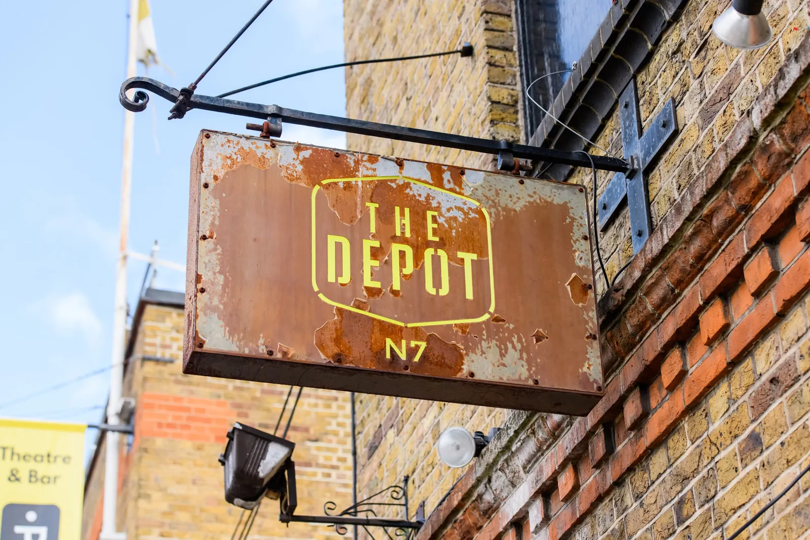 Exterior photography of The depot N7 rustic sign on side of building