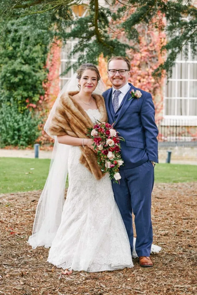 Happy bride and groom smiling outside during their winter wedding at Beaumont Estate